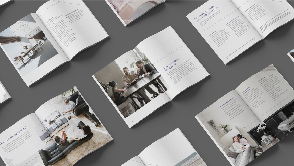Display showcasing various spreads of The Private Bank brochure