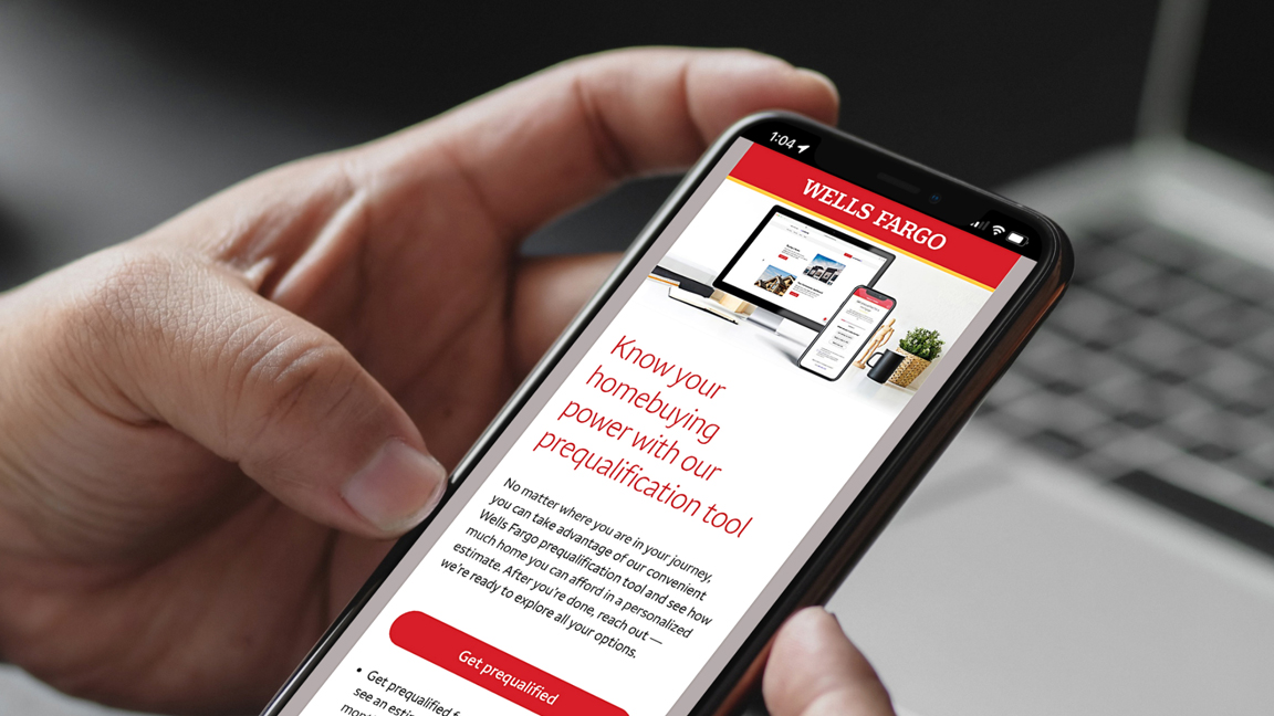 Close up of hand holding mobile phone displaying Home Mortgage email