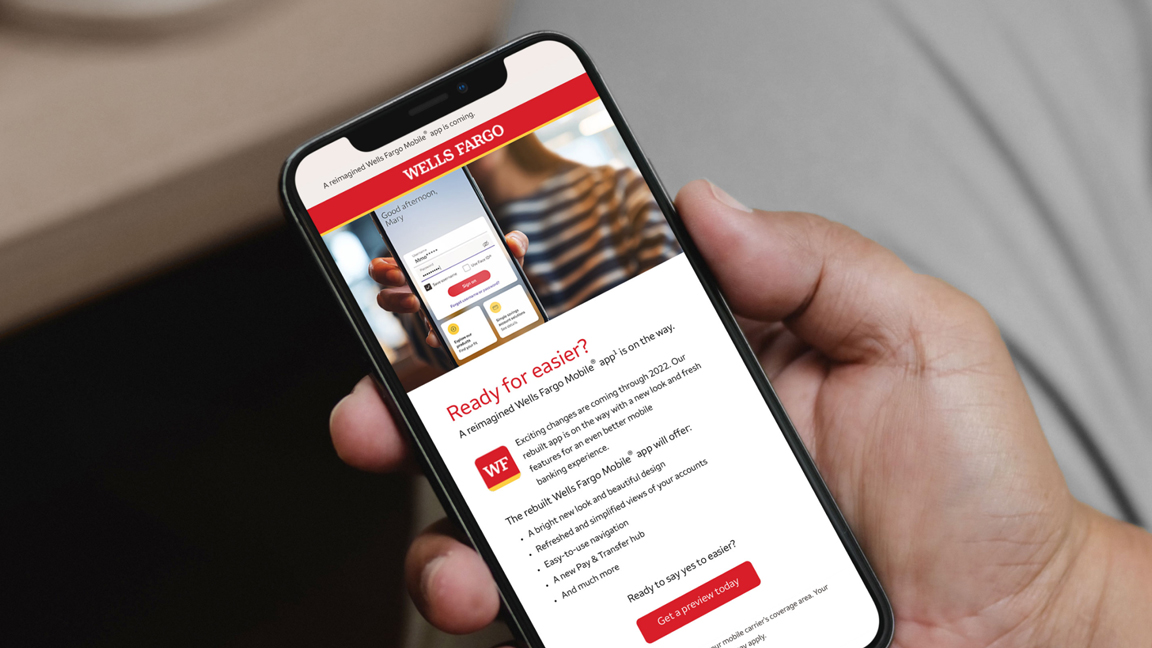 Close up of man's hand, reading Wells Fargo Mobile App email on his phone